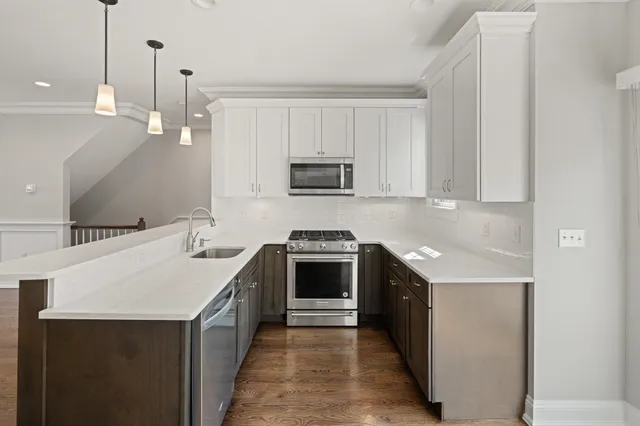a kitchen with a sink stove and microwave