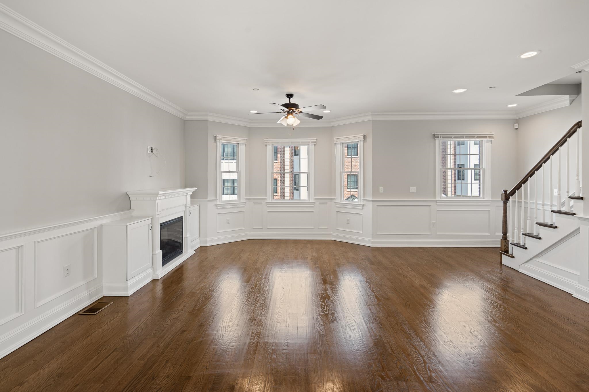 4 Central Avenue, Unit D Caldwell, NJ 07006 - Photo 7 of 32 a view of an empty room with wooden floor and a fireplace