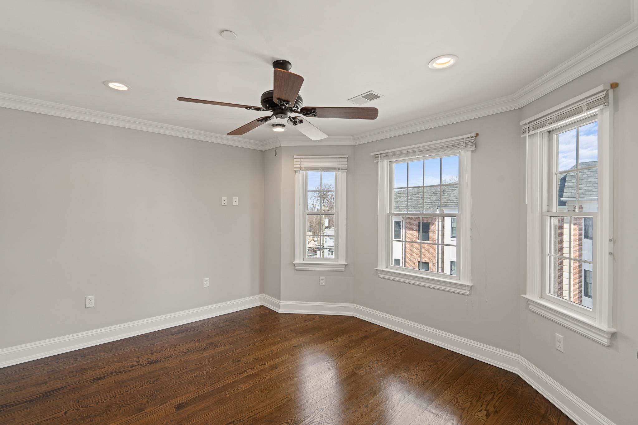 4 Central Avenue, Unit D Caldwell, NJ 07006 - Photo 9 of 32 a view of an empty room with a window and wooden floor