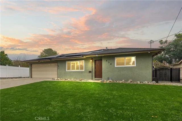 a front view of house with yard and green space
