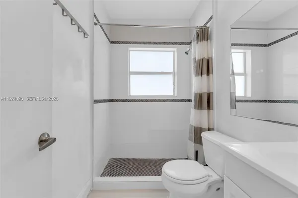 a bathroom with a toilet a sink and a shower