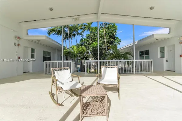 a view of a chair and tables in patio of the house