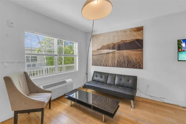 a living room with a couch and a window