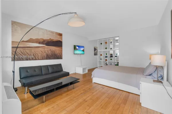 a bedroom with a bed and a mirror