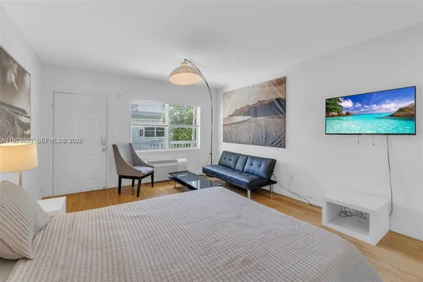 a bedroom with furniture and a window