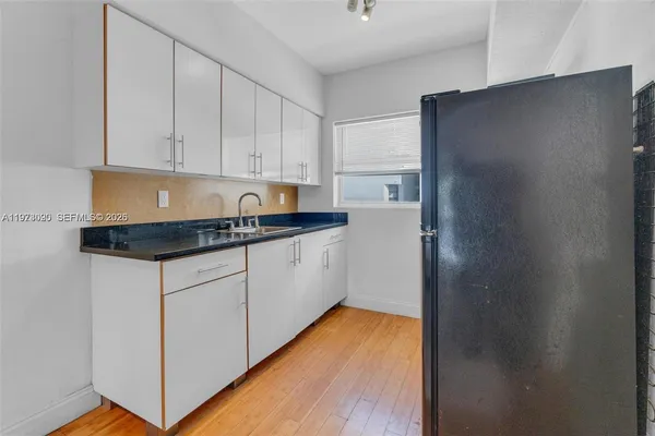 a kitchen with stainless steel appliances granite countertop refrigerator sink and cabinets