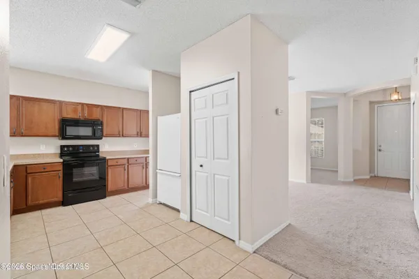 a kitchen with stainless steel appliances a refrigerator and a stove top oven