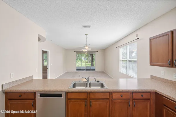 a kitchen with a sink a window and cabinets