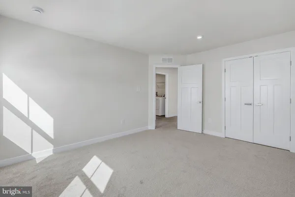 a view of an empty room and closet area