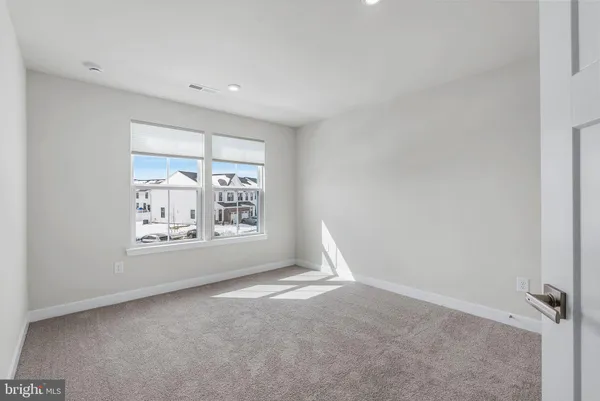 a view of a house with a wooden fence