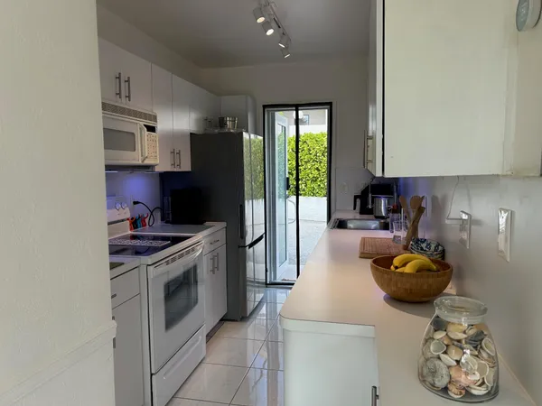 a kitchen with stainless steel appliances granite countertop a stove a refrigerator and a sink