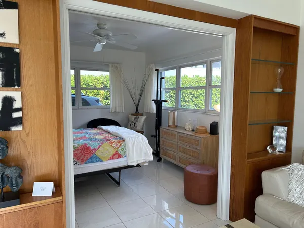 a bedroom with furniture and a window