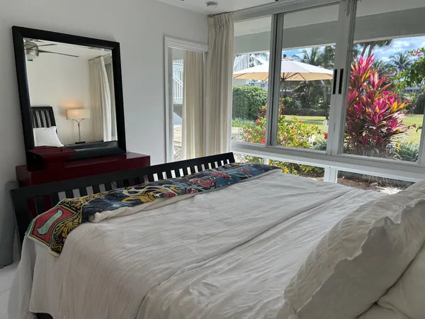 a bedroom with a bed and a large mirror