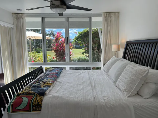 a bedroom with furniture and a large window