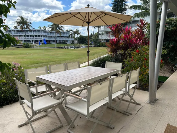 a view of a chairs and table in the yard