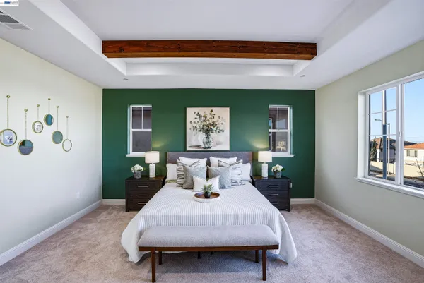 a bedroom with a bed a table and painting