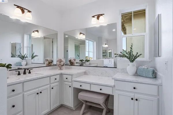 a bathroom with a sink double vanity and a mirror