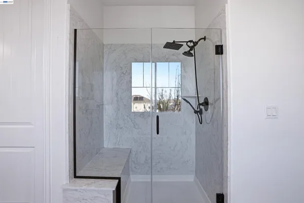a bathroom that has a glass shower door