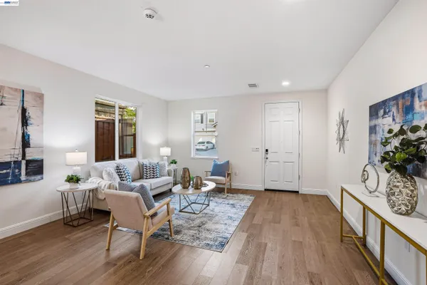 a living room with furniture and wooden floor