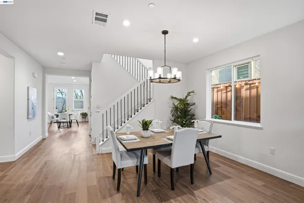 a view of a dining room with furniture window and wooden floor