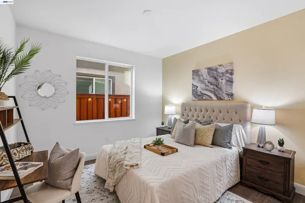 a bedroom with bed and wooden floor