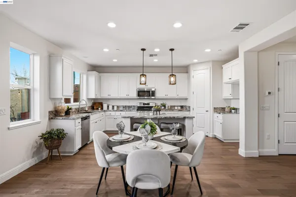 a kitchen with a table and chairs in it