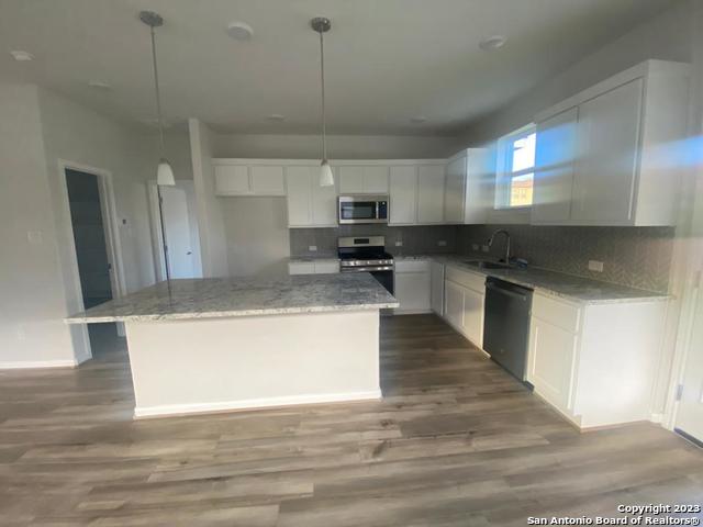 8338 Morningside Place Selma, TX 78154 - Photo 6 of 8 a large kitchen with stainless steel appliances granite countertop a stove a sink and a refrigerator