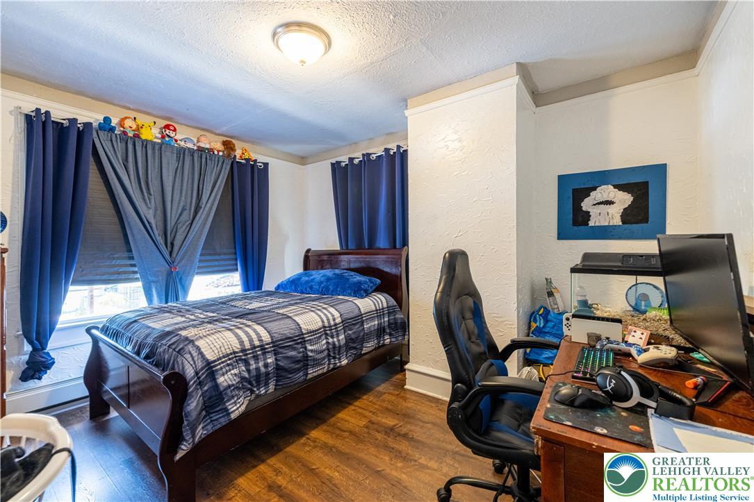 118 South 3rd Street Bangor, PA 18013 - Photo 16 of 33 This cozy room features durable hardwood flooring, ideal for comfortable living and personal retreat.