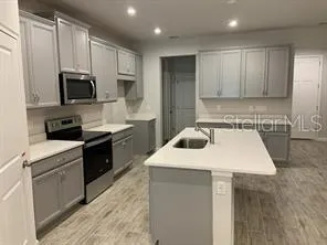 a kitchen with a sink a stove and refrigerator