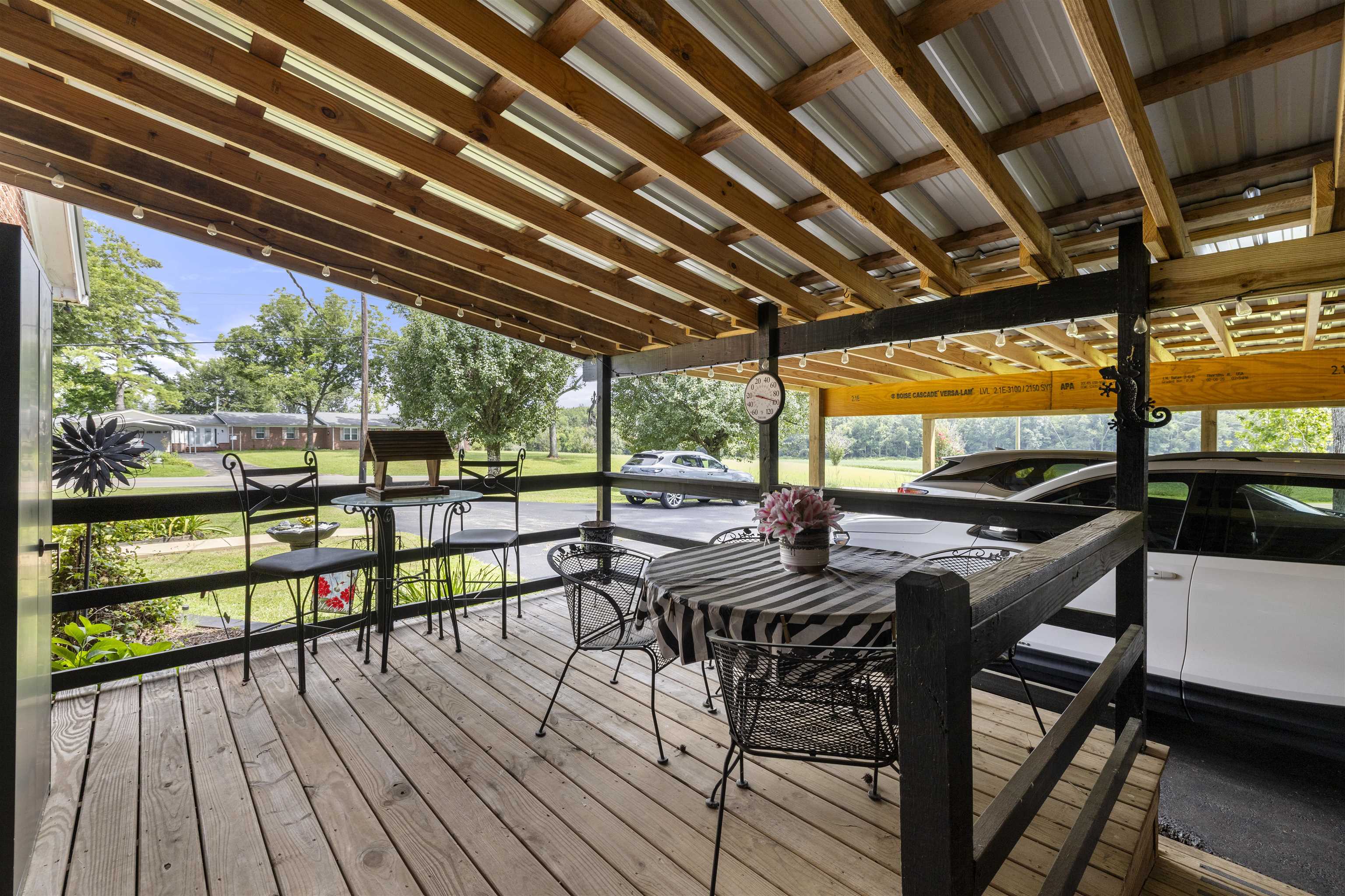 2665 Powell Chapel Road Middleton, TN 38052 - Photo 24 of 36 Covered wood-plank deck with a metal roof and exposed wood beams