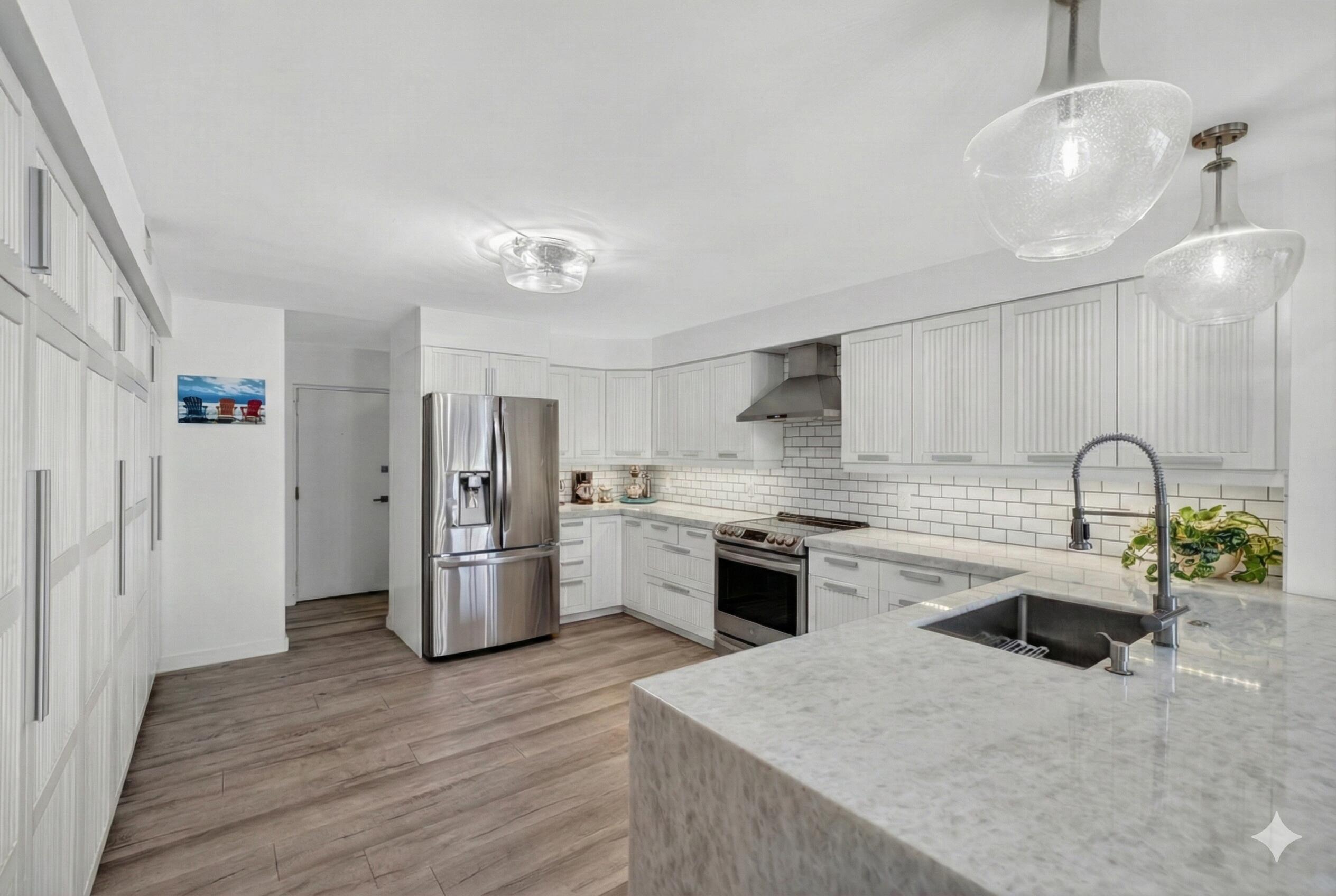 777 Bayshore Drive, Unit 1003 Fort Lauderdale, FL 33304 - Photo 11 of 49 a kitchen with a sink stainless steel appliances and ceiling fan