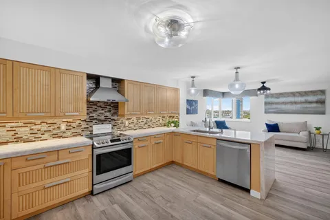 a bathroom with a granite countertop sink a mirror and a shower