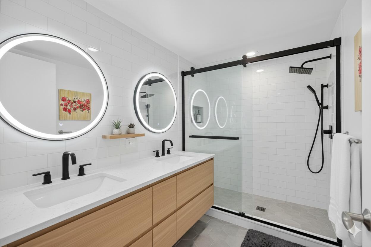 777 Bayshore Drive, Unit 1003 Fort Lauderdale, FL 33304 - Photo 24 of 49 a bathroom with a double vanity sink mirror and shower