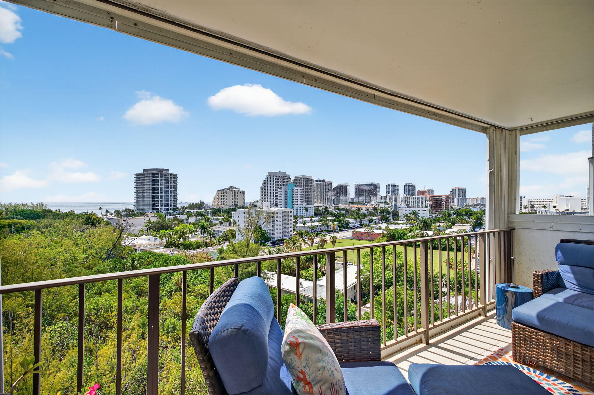 777 Bayshore Drive, Unit 1003 Fort Lauderdale, FL 33304 - Photo 28 of 49 a view of a balcony with wooden chairs and floor to ceiling window