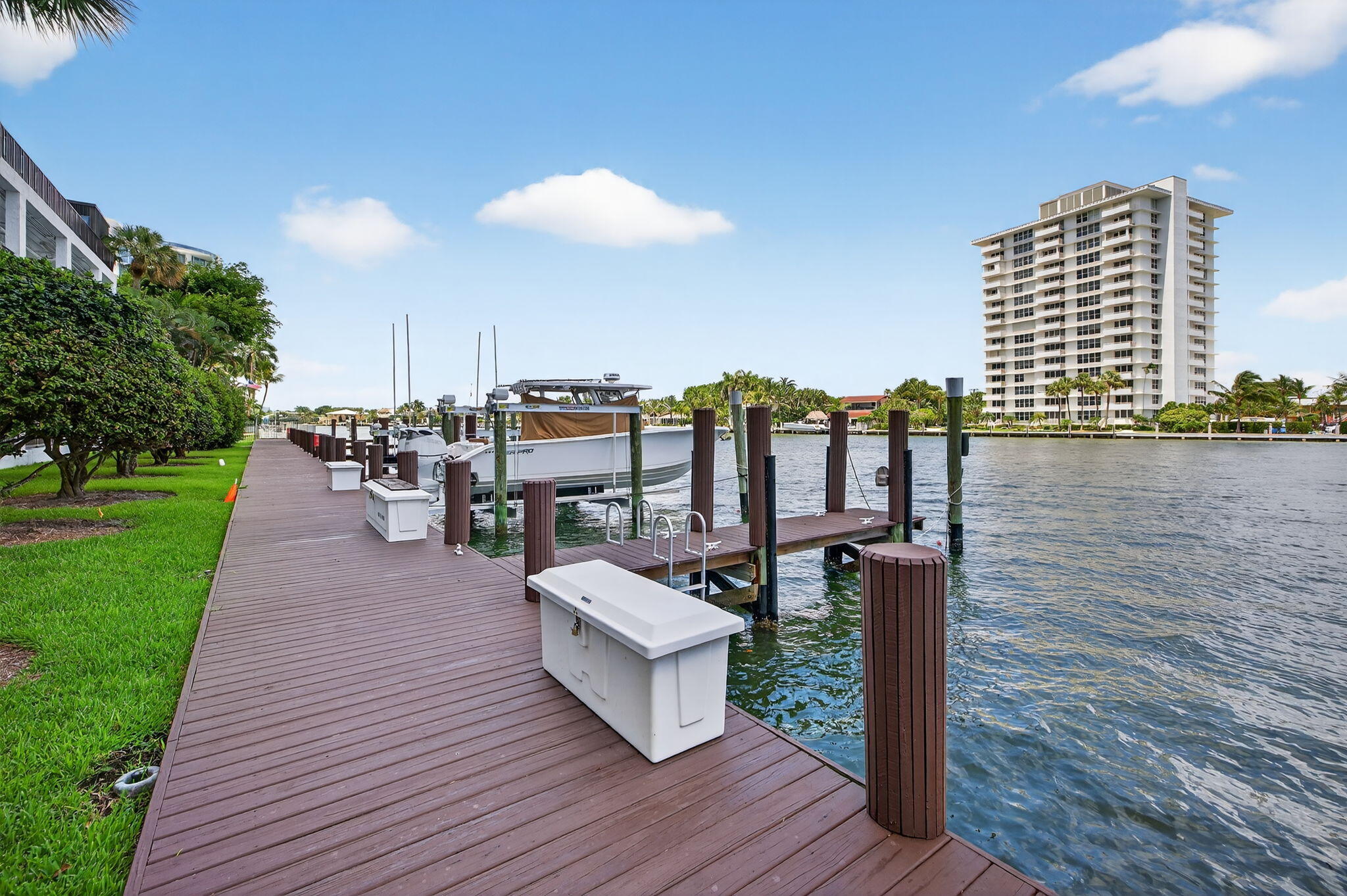 777 Bayshore Drive, Unit 1003 Fort Lauderdale, FL 33304 - Photo 35 of 49 a view of a patio with table and chairs with wooden floor and fence