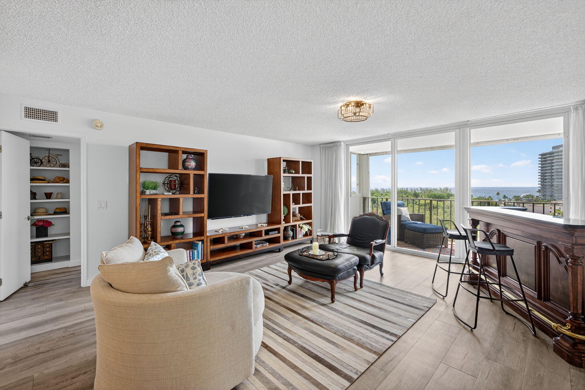 777 Bayshore Drive, Unit 1003 Fort Lauderdale, FL 33304 - Photo 9 of 49 a living room with furniture and a flat screen tv