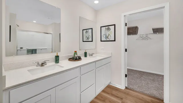 a bathroom with a double vanity sink and mirror