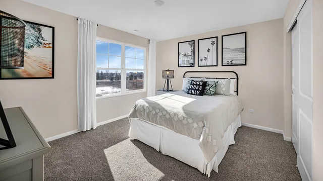 a bedroom with a large bed and a painting on the wall