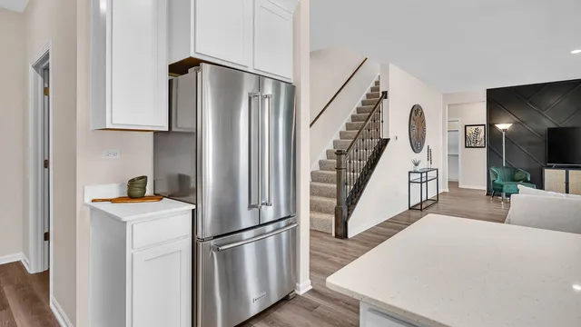 a kitchen with white cabinets and white appliances
