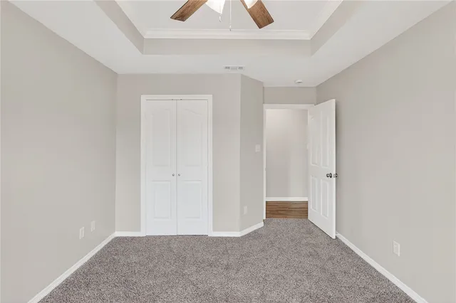 a view of a room with a ceiling fan