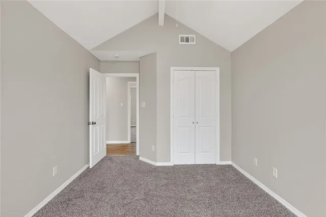 a view of an empty room and closet area
