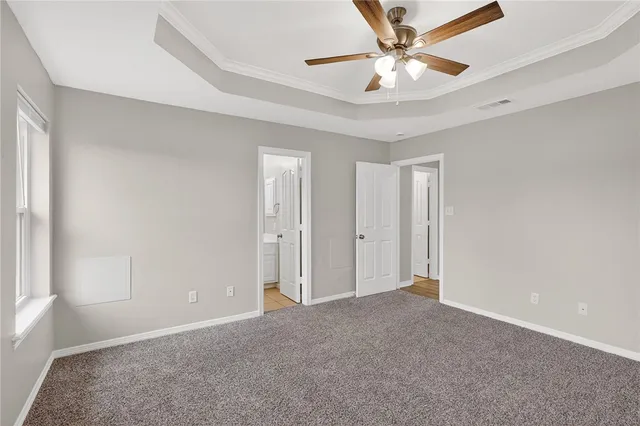 a view of an empty room and a ceiling fan