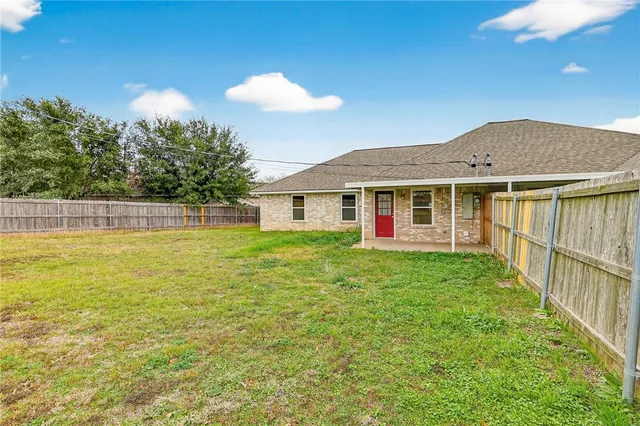 a view of a house with a backyard