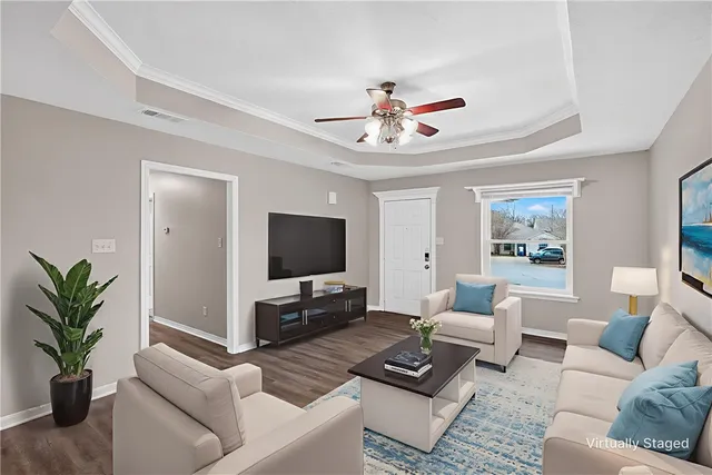 a living room with furniture a fireplace and a flat screen tv
