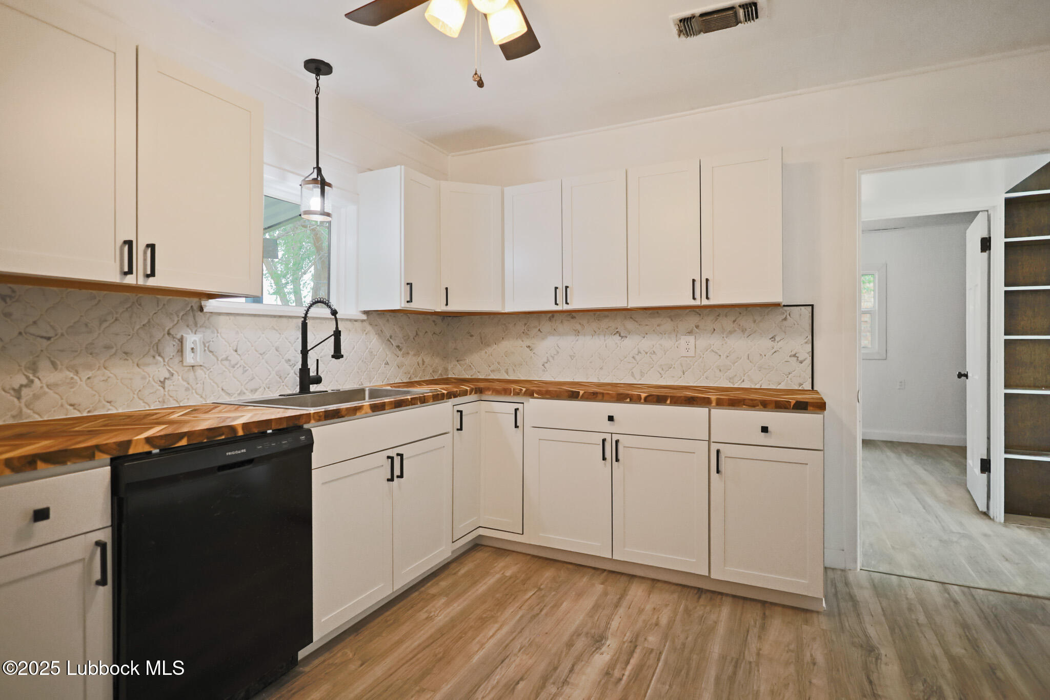 204 Chestnut Street Ropesville, TX 79358 - Photo 11 of 42 a kitchen with granite countertop white cabinets and white appliances