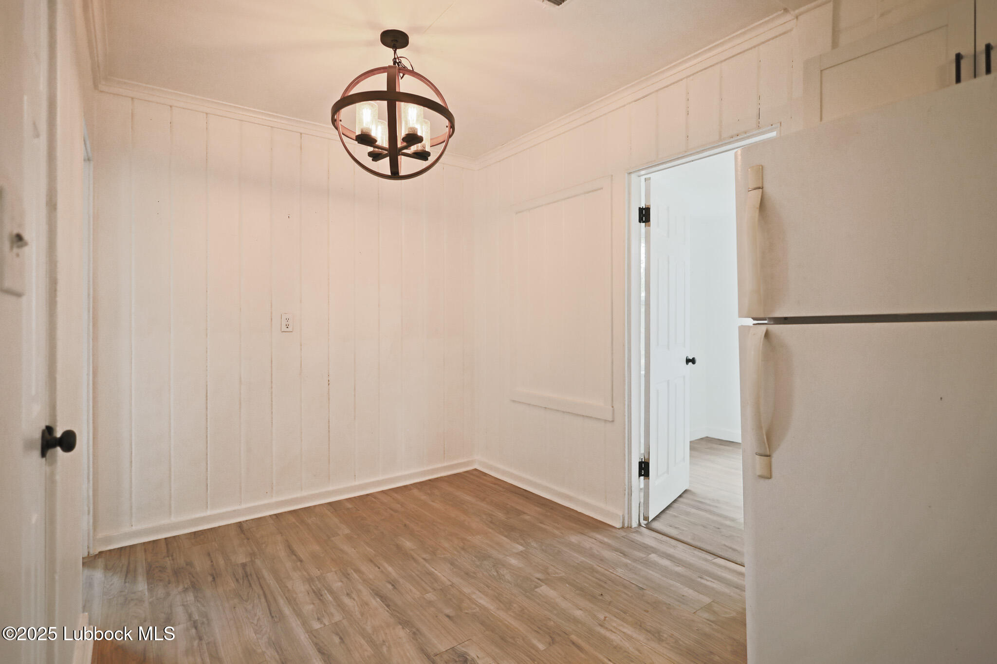 204 Chestnut Street Ropesville, TX 79358 - Photo 13 of 42 a view of empty room with wooden floor and white walls
