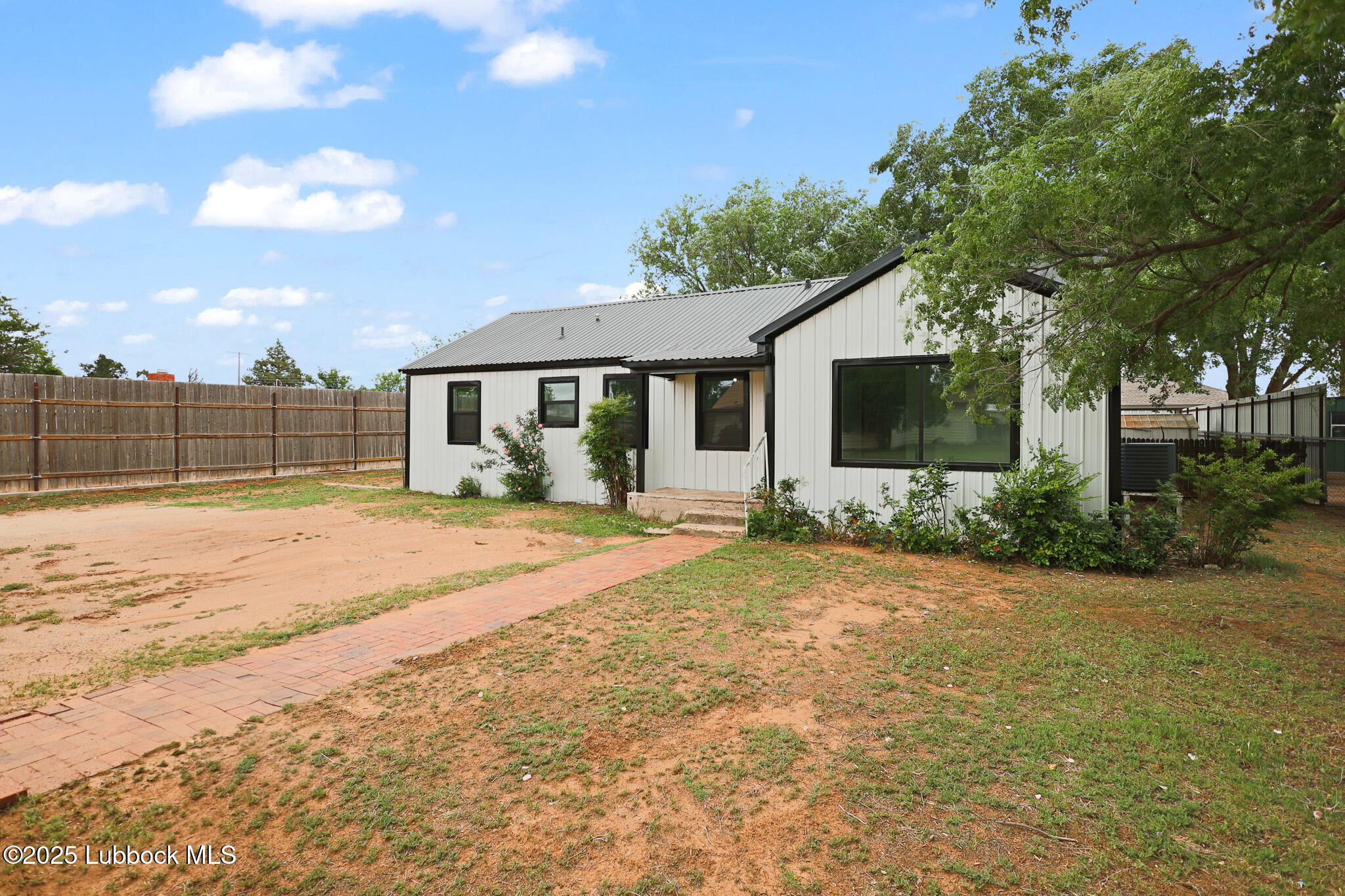 204 Chestnut Street Ropesville, TX 79358 - Photo 3 of 42 a front view of a house with a yard and potted plants