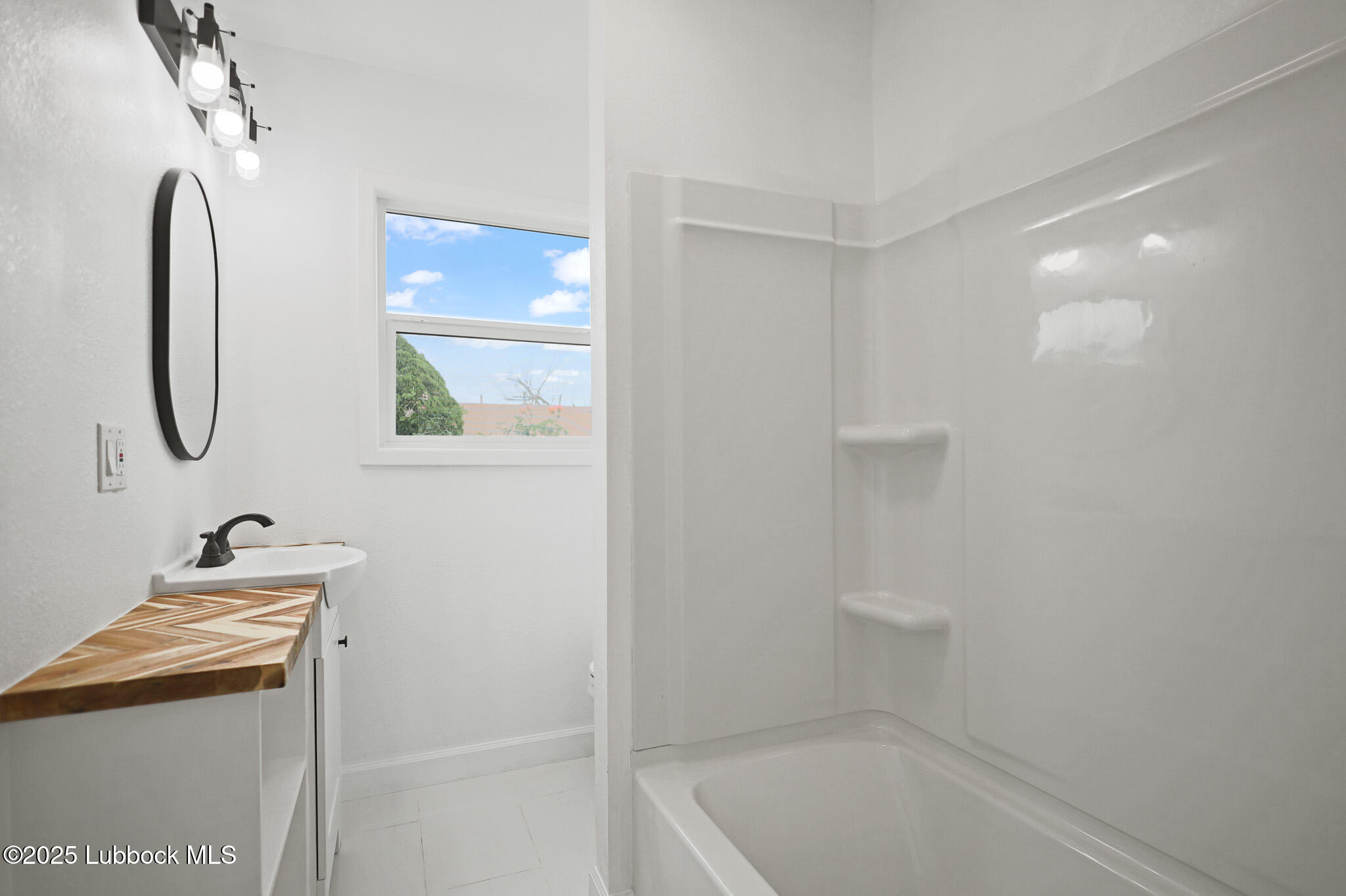 204 Chestnut Street Ropesville, TX 79358 - Photo 32 of 42 a bathroom with a tub sink and mirror