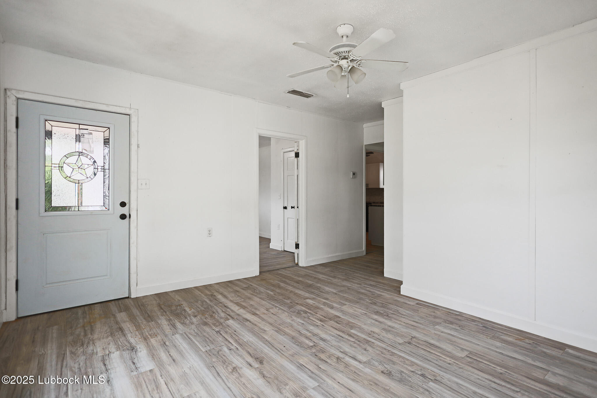 204 Chestnut Street Ropesville, TX 79358 - Photo 4 of 42 a view of an empty room with wooden floor