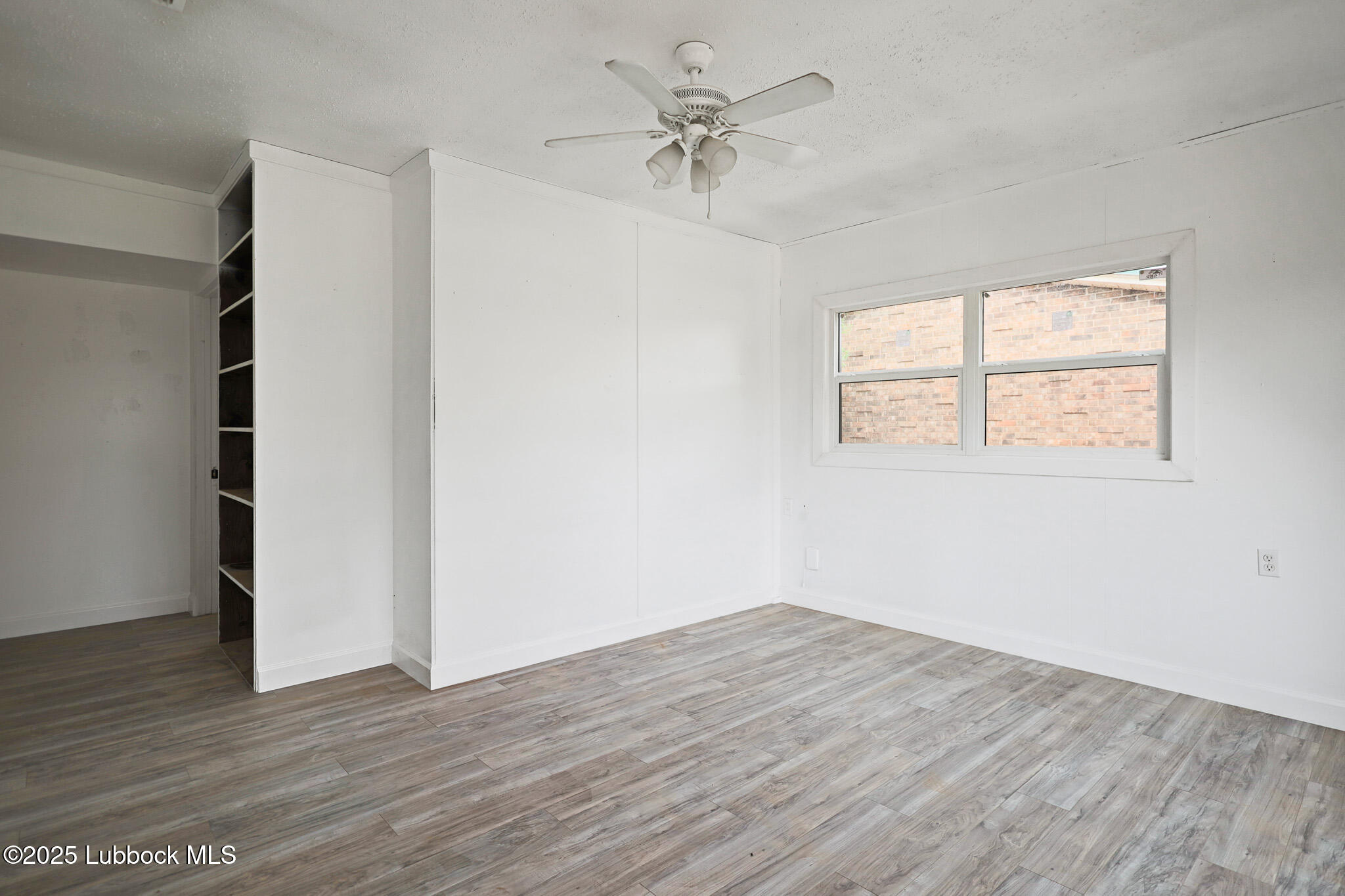 204 Chestnut Street Ropesville, TX 79358 - Photo 5 of 42 wooden floor in an empty room with a window